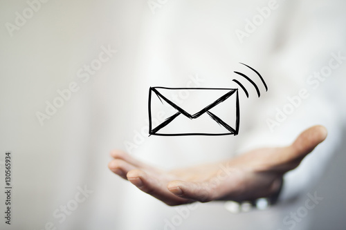 man holds a virtual postal envelope, concept of emai photo