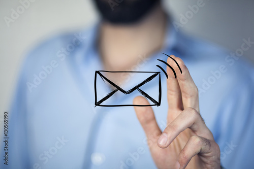 man holds a virtual postal envelope, concept of emai photo