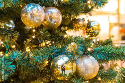 Photographer reflected in golden Christmas balls