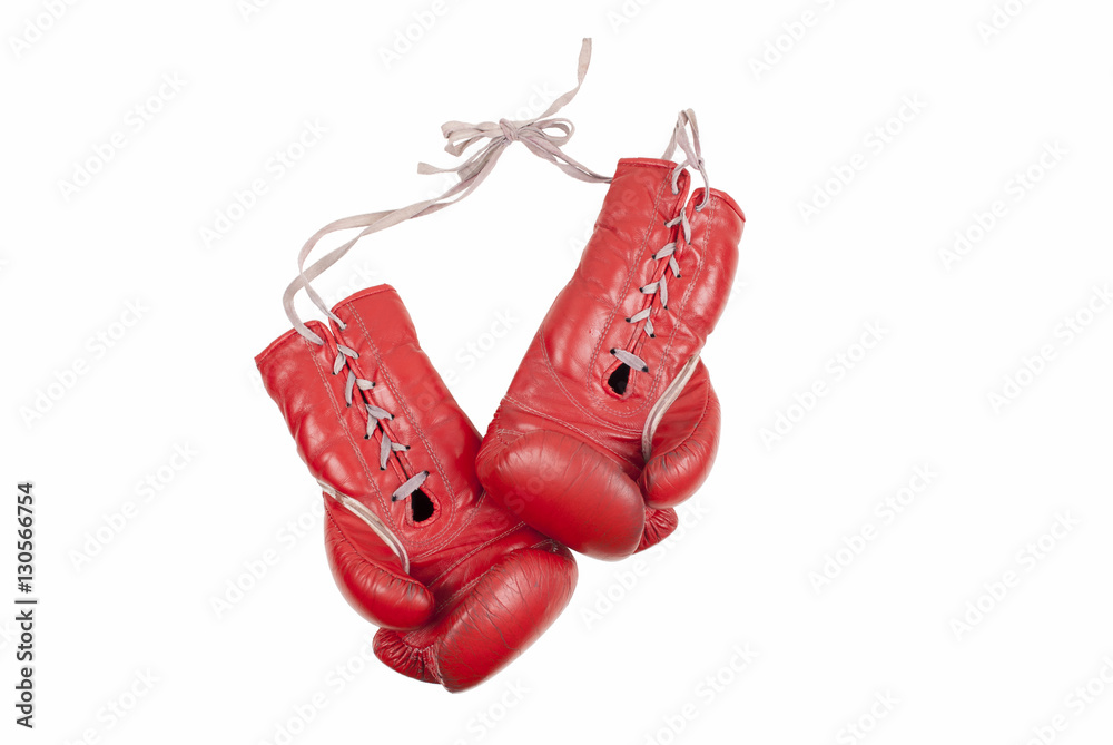 old used and battered red leather boxing gloves with laces isolated on white background