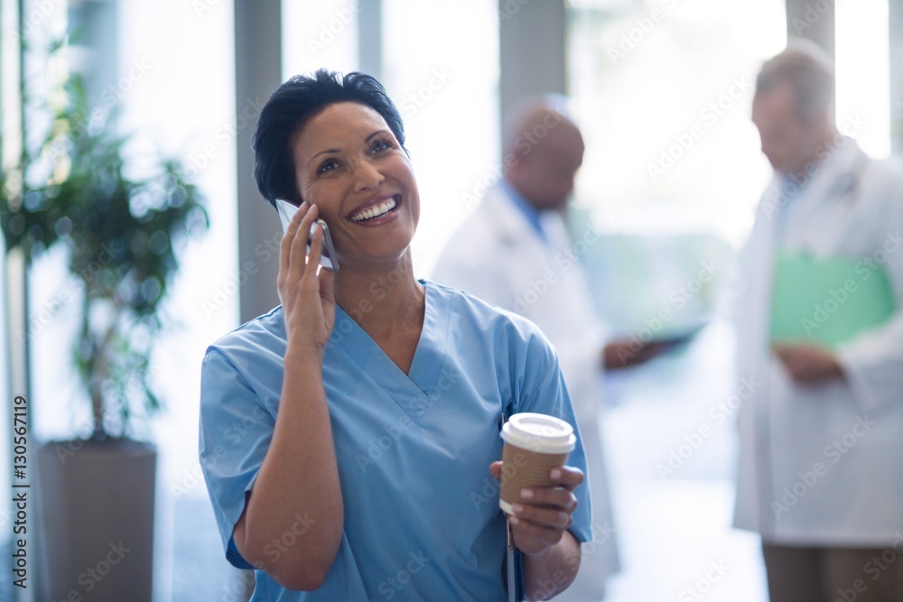 © WavebreakMediaMicro - Female doctor talking on mobile phone © WavebreakMediaMicro - Female doctor talking on mobile phone