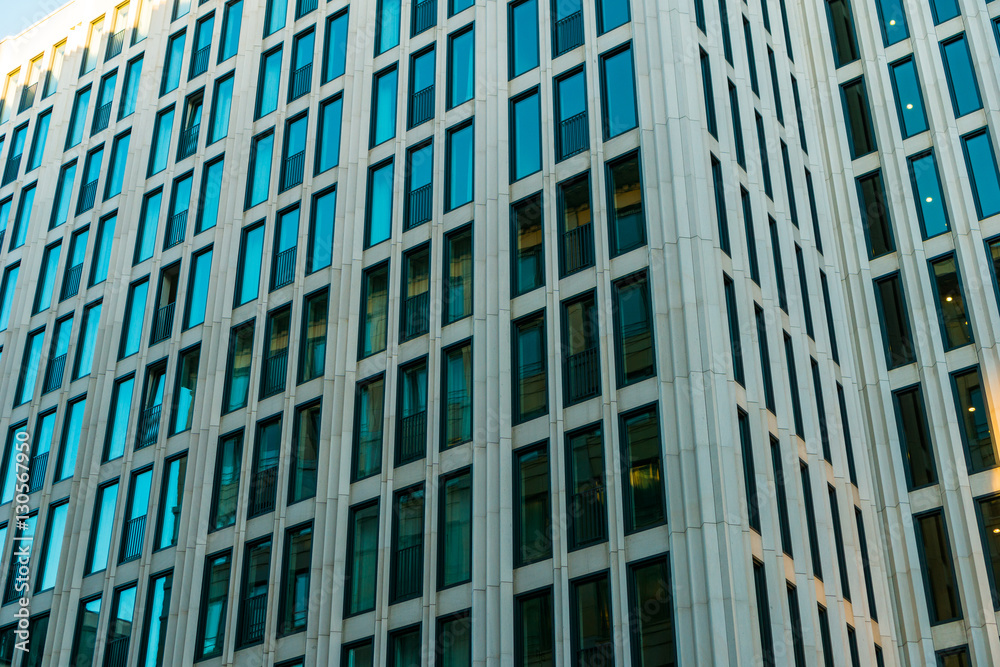 white finance building with small blue windows