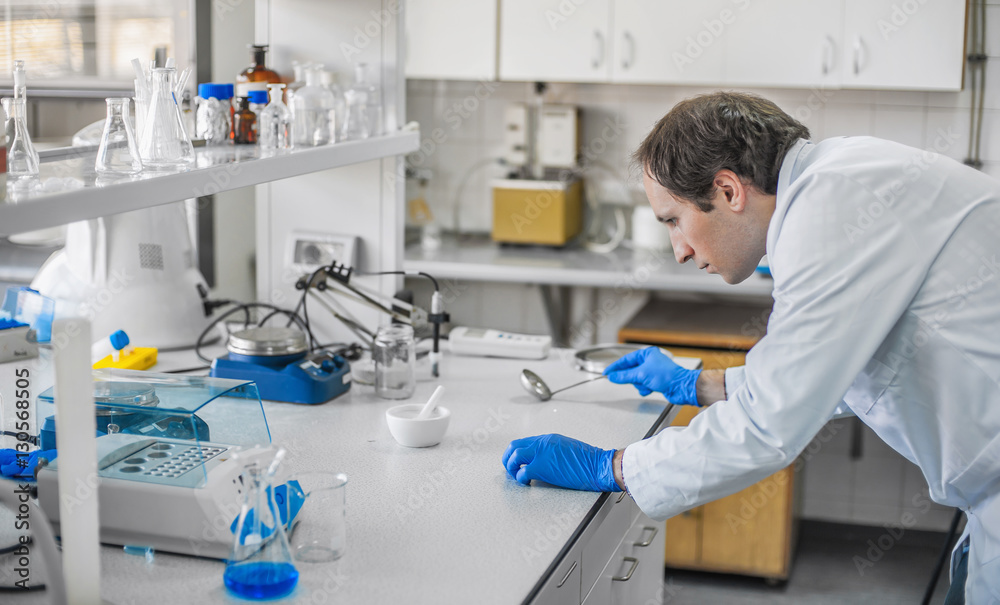 Male laboratory researcher performs tests Male laboratory researcher performs tests