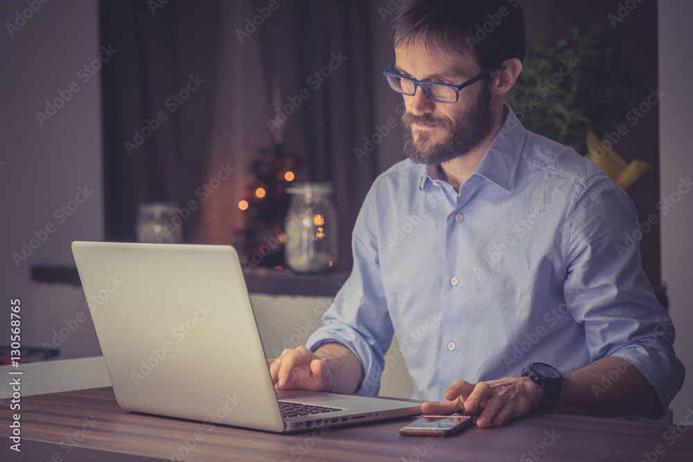 Man working on a laptop at night Man working on a laptop at night