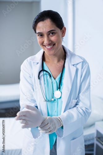 Beautiful doctor wearing gloves in hospital