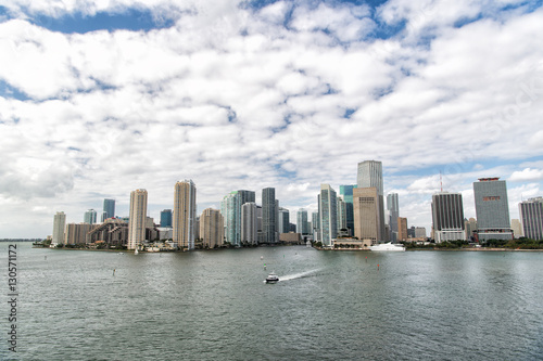 Aerial view of Miami skyscrapers with blue cloudy sky  boat sail