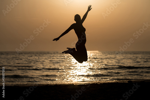 Siluet Woman With Raised Hands And Jumping Around