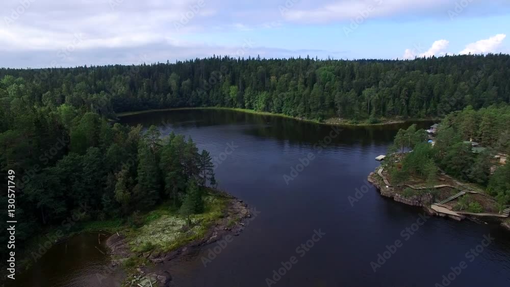 The camera flies over water Ladoga lake and forest. The landscape of the island of Valaam. Journey to the Holy places. The camera flies over water Ladoga lake and forest. The landscape of the island of Valaam. Journey to the Holy places.