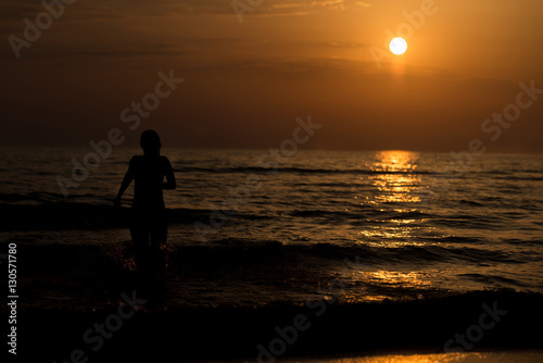 Silhouette of Girl in the Water at Sunset