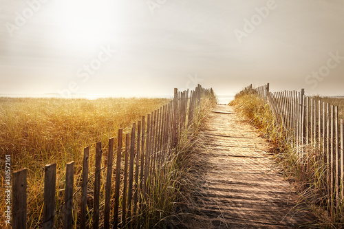 Fenced wooden boardwalk to the beach
