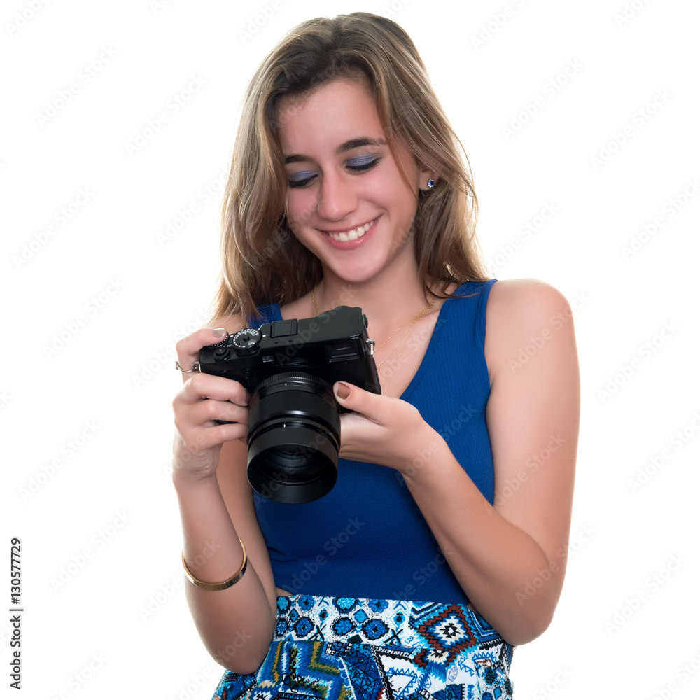 Pretty teenage girl looking at pictures on the rear display of a professional camera - Isolated on white Pretty teenage girl looking at pictures on the rear display of a professional camera - Isolated on white