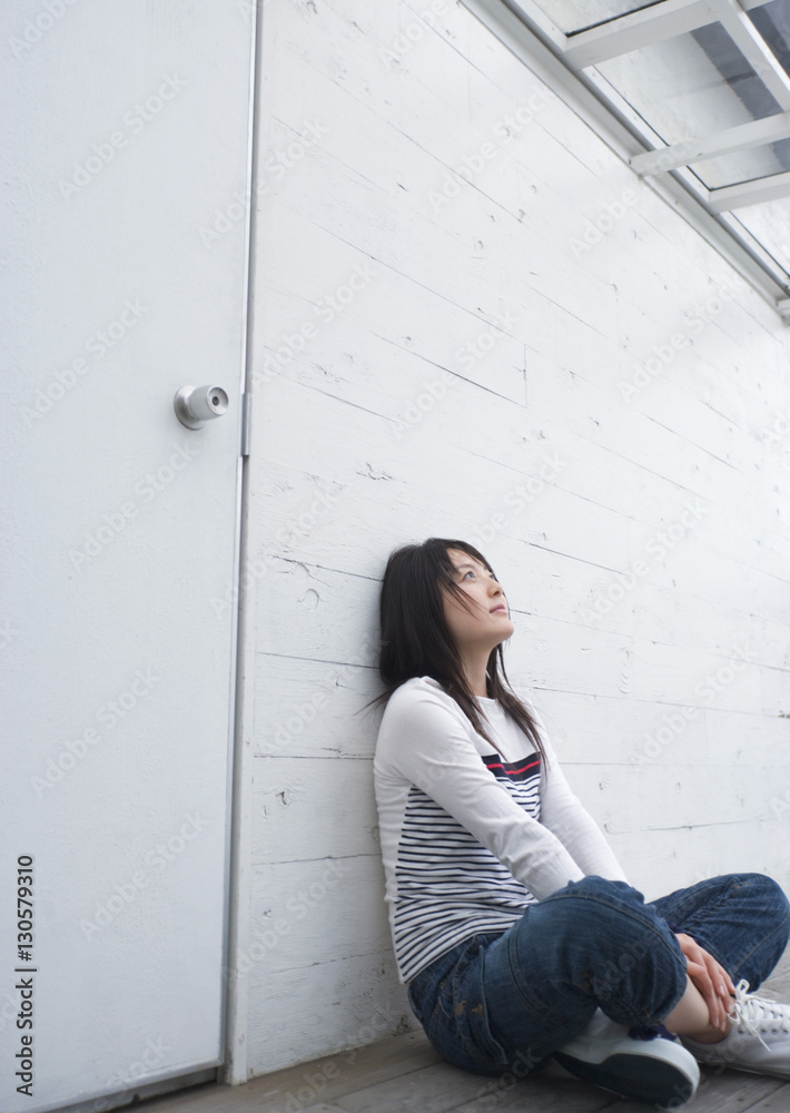 Teenage girl leaning against wall Teenage girl leaning against wall