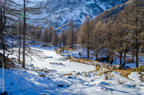 Frozen Lago Blu basked in afternoon light, Valtournenche, Aosta Valley photo