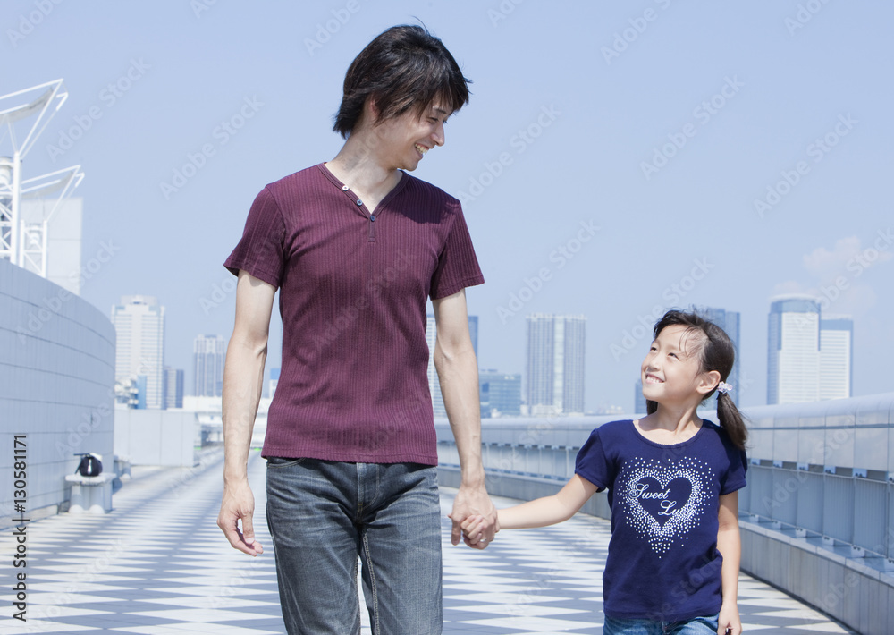 Father and daughter holding hands