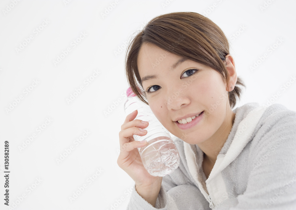 Young woman holding bottle of mineral water Young woman holding bottle of mineral water