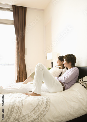 Couple relaxing on bed
