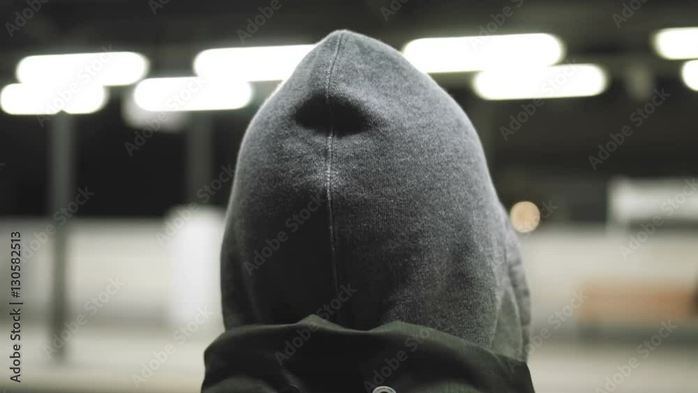 MIllenial youth in hoodie at the train station at night, slomo 100p.A hooded young man is waiting for the train or walking along the platform with or witout his hoodie on, at night. MIllenial youth in hoodie at the train station at night, slomo 100p.A hooded young man is waiting for the train or walking along the platform with or witout his hoodie on, at night.