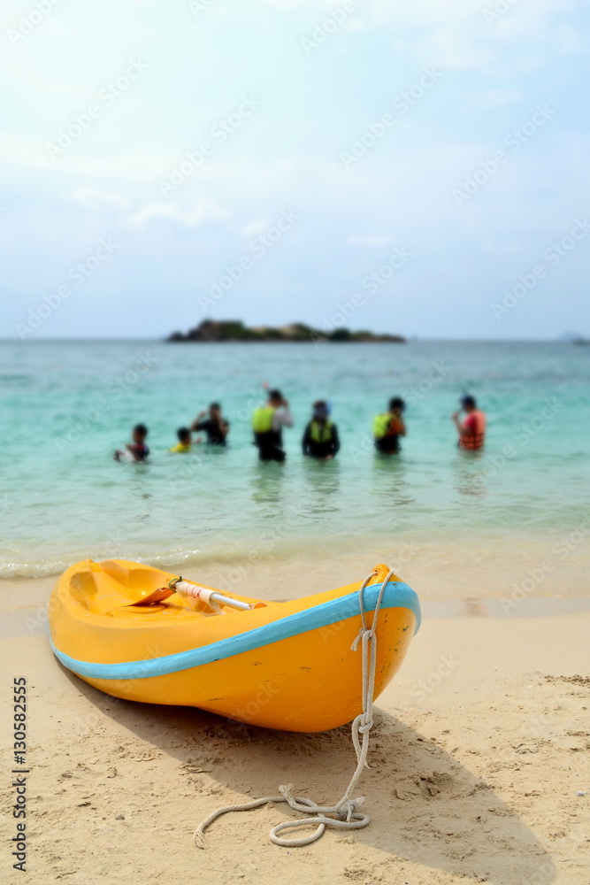 Yellow kayak on beach in evening day with blue sea background. Yellow kayak on beach in evening day with blue sea background.