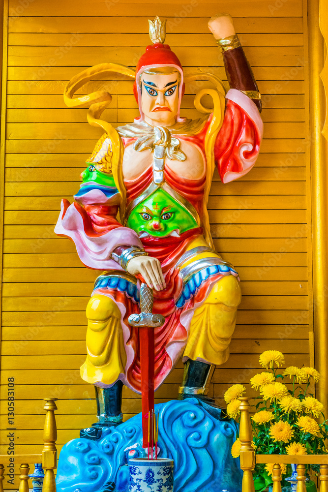 Sculpture of wicked god warrior in buddhist temple in Dalat Vietnam