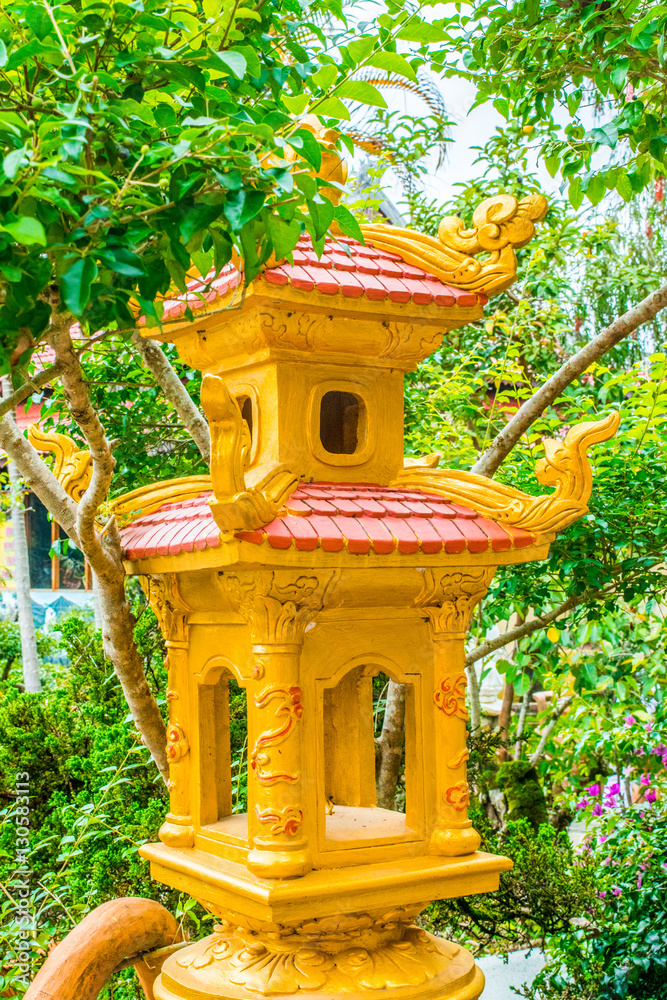 Yellow Oriental Buddhist lantern in a garden of temple in Dalat Vietnam