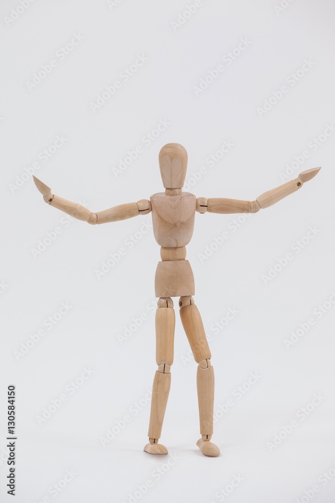 Wooden figurine standing with arms spread wide Wooden figurine standing with arms spread wide
