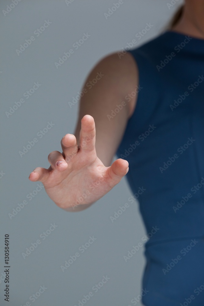 Hand of a woman touching invisible screen Hand of a woman touching invisible screen