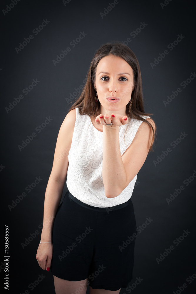 Beautiful woman doing different expressions in different sets of clothes: kiss Beautiful woman doing different expressions in different sets of clothes: kiss