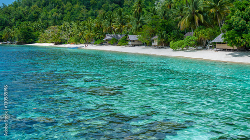 Bamboo Huts on the Beach  Coral Reef of an  Homestay  Gam Island  West Papuan  Raja Ampat  Indonesia