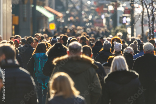 Crowd of people walking on a street