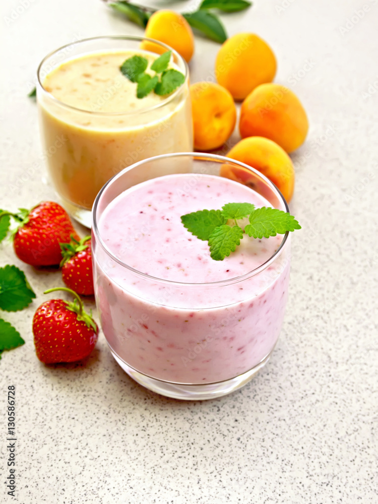 Milkshake strawberry and apricot on granite table Milkshake strawberry and apricot on granite table