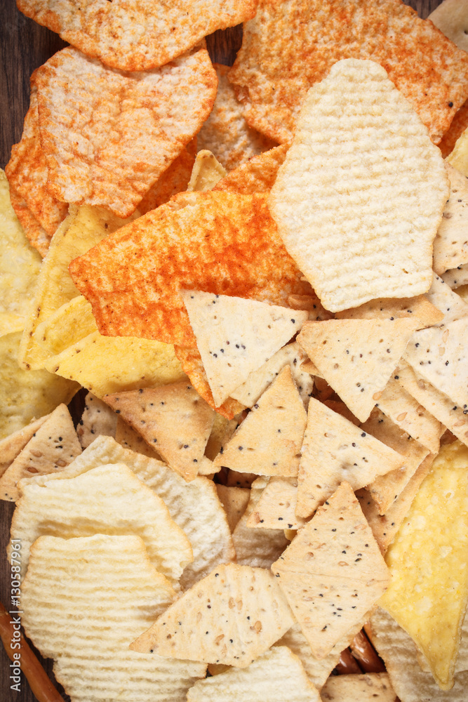 Heap of salted crisps, breadsticks and cookies, concept of unhealthy food Heap of salted crisps, breadsticks and cookies, concept of unhealthy food