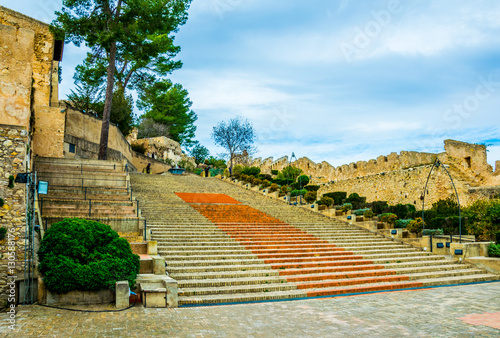 view of a steep stairway situated inside of the xativa castle in spain photo