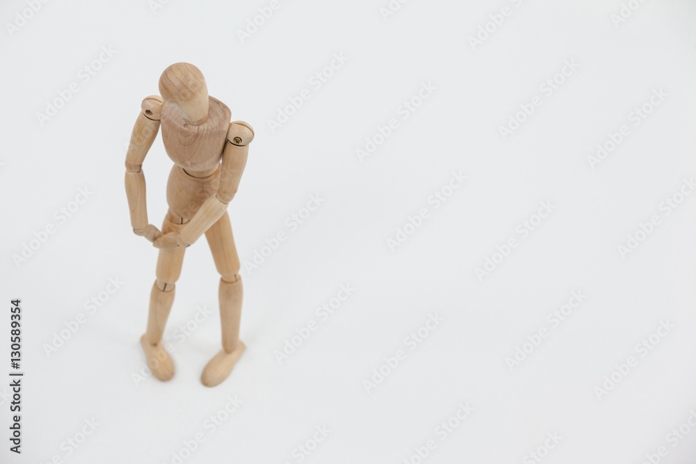 Wooden figurine standing with hands on knee Wooden figurine standing with hands on knee