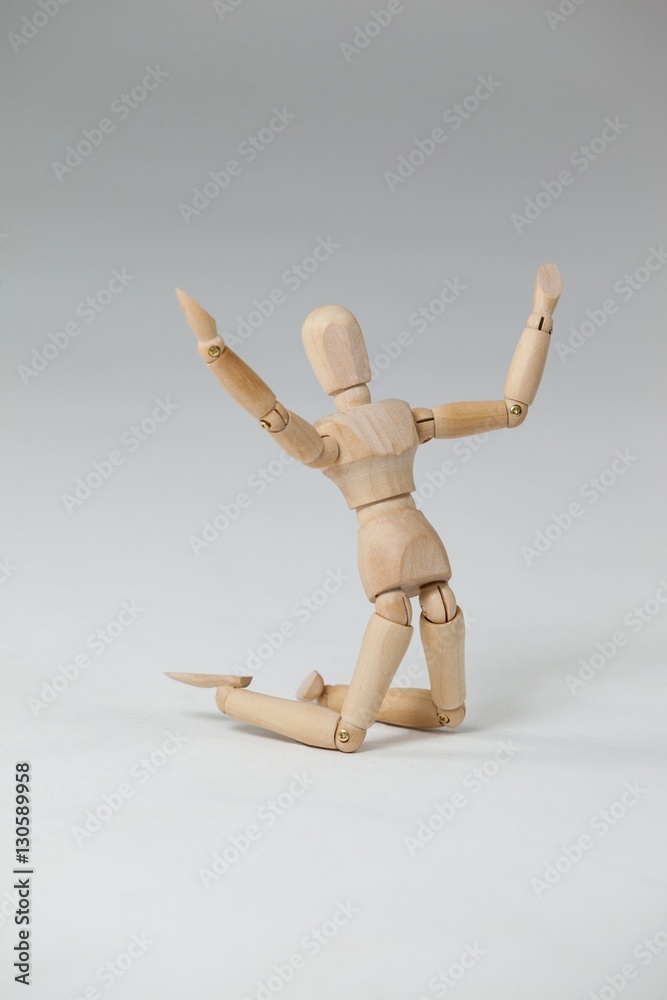 Wooden figurine kneeling with arms spread wide Wooden figurine kneeling with arms spread wide