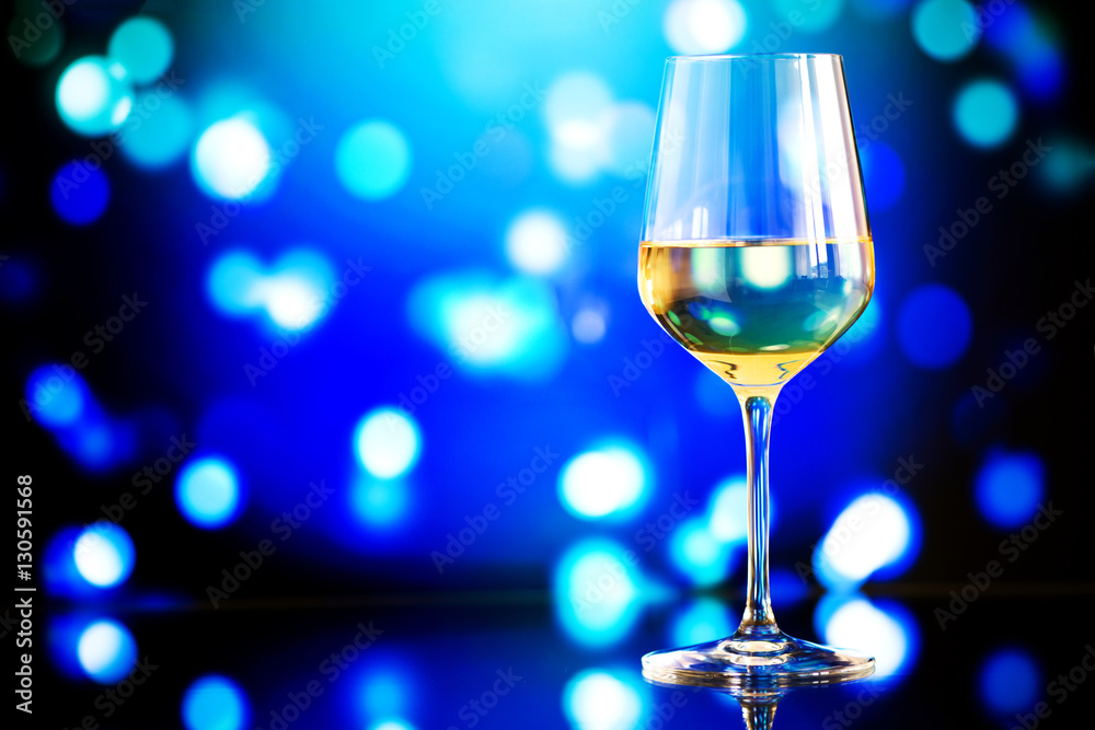 glass of white wine against a glowing bokeh - copy space, select glass of white wine against a glowing bokeh - copy space, select