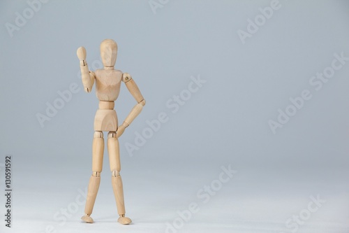 Wooden figurine standing and showing his fist