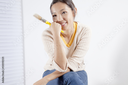 Young woman holding a painting brush
