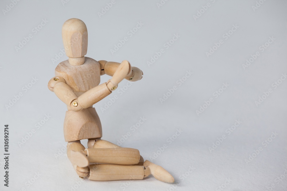 Wooden figurine performing yoga on floor Wooden figurine performing yoga on floor