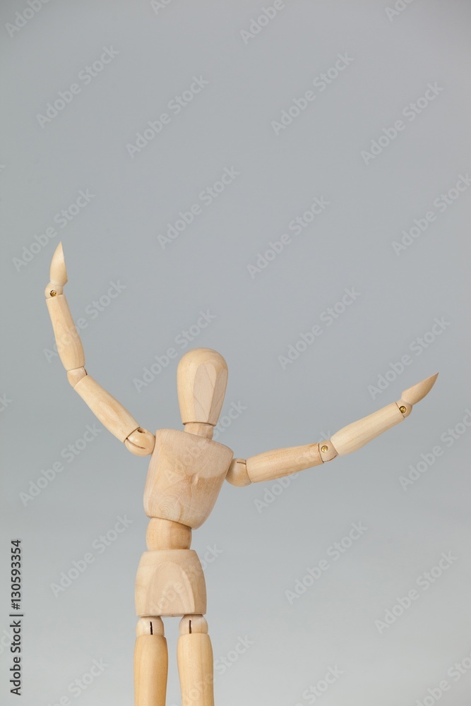 Wooden figurine standing with arms spread wide Wooden figurine standing with arms spread wide