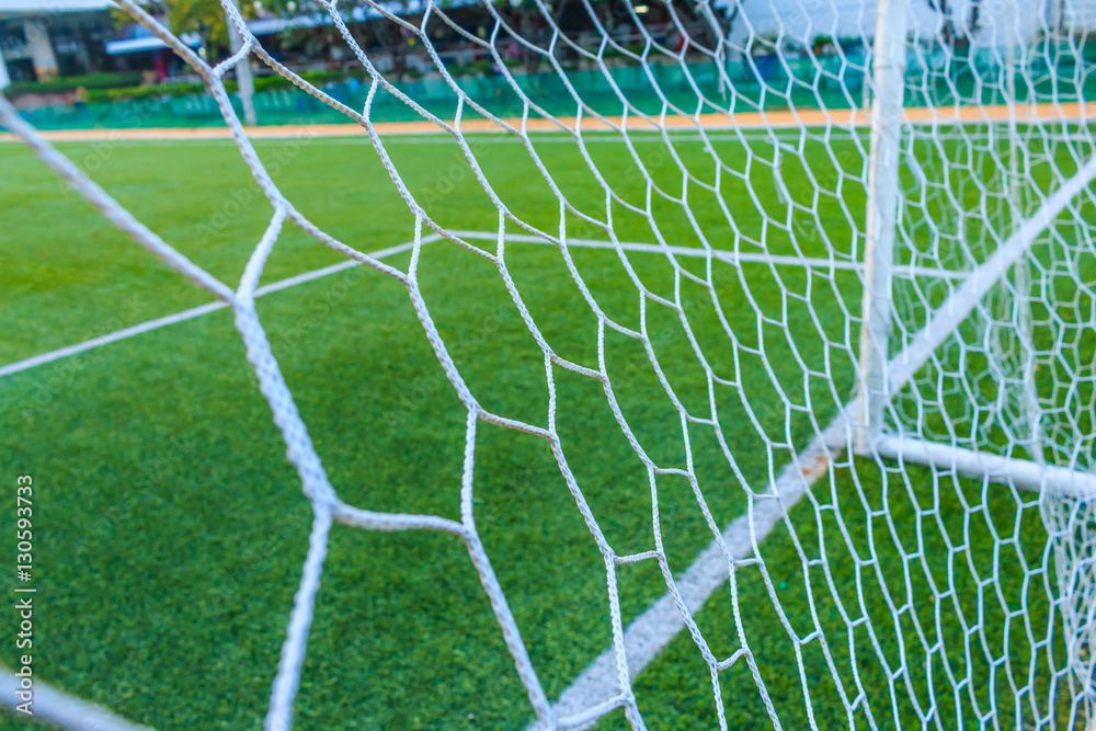 Fototapeta premium The nets of football goal with field artificial grass