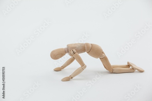 Wooden figurine exercising on floor