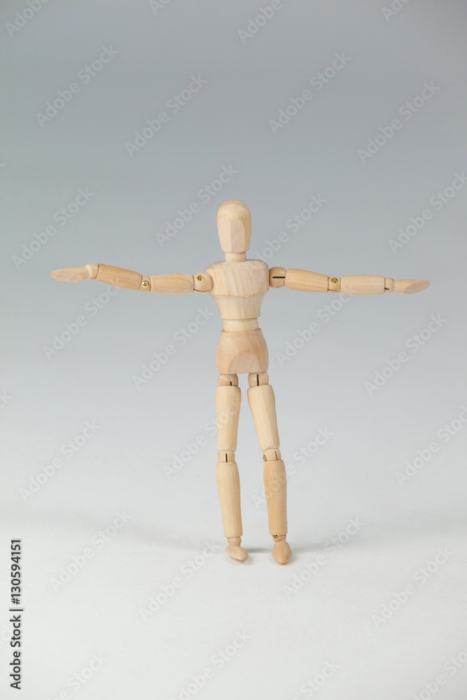 Wooden figurine standing with arms spread wide Wooden figurine standing with arms spread wide