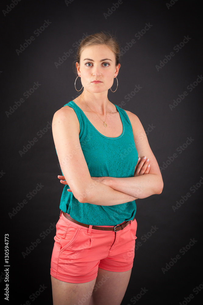 Beautiful woman doing different expressions in different sets of clothes: arms crossed Beautiful woman doing different expressions in different sets of clothes: arms crossed
