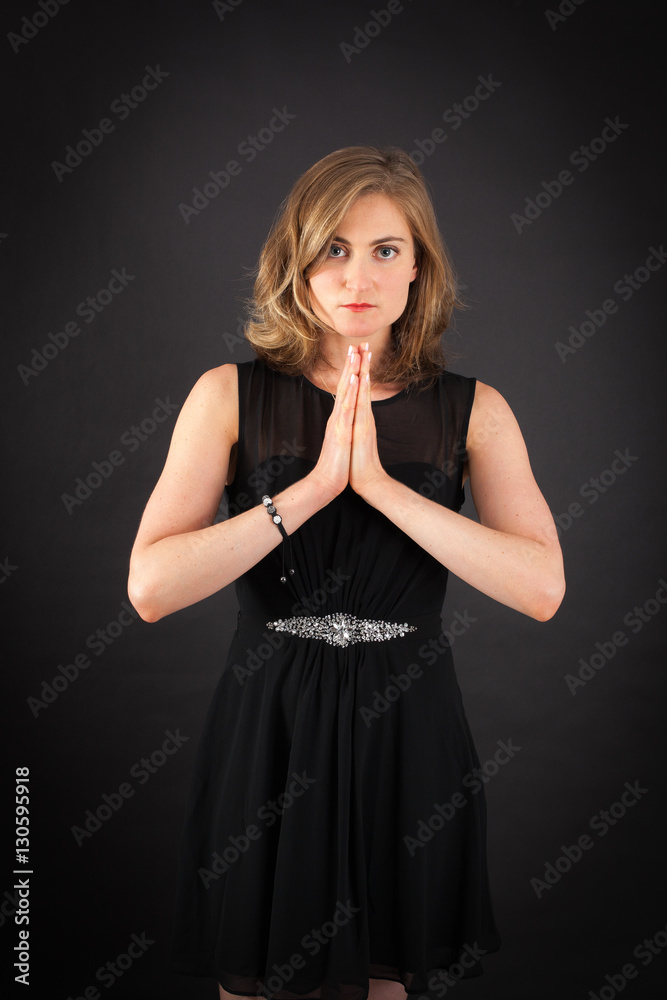 Beautiful woman doing different expressions in different sets of clothes: prayer Beautiful woman doing different expressions in different sets of clothes: prayer