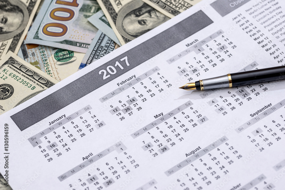 calendar with a pen and dollars. calendar with a pen and dollars.