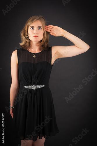 Beautiful woman doing different expressions in different sets of clothes: at attention