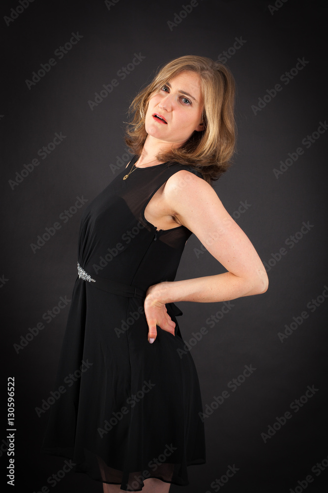 Beautiful woman doing different expressions in different sets of clothes: backache Beautiful woman doing different expressions in different sets of clothes: backache