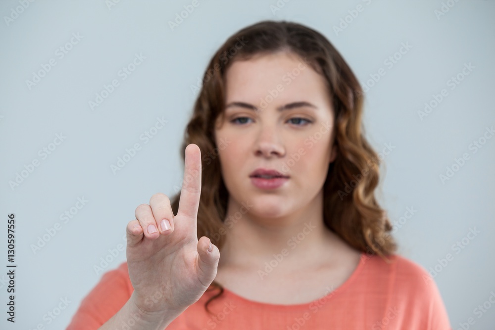 Woman pretending to touch an invisible screen Woman pretending to touch an invisible screen