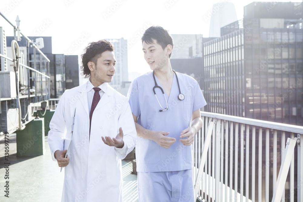 Two doctors are talking on the rooftop Two doctors are talking on the rooftop