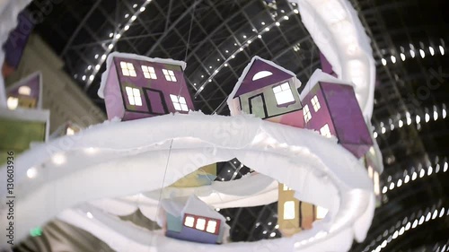 Toy house for New Year's and Christmas decorations in the malls, in the central part. Decorations hang ceiling.